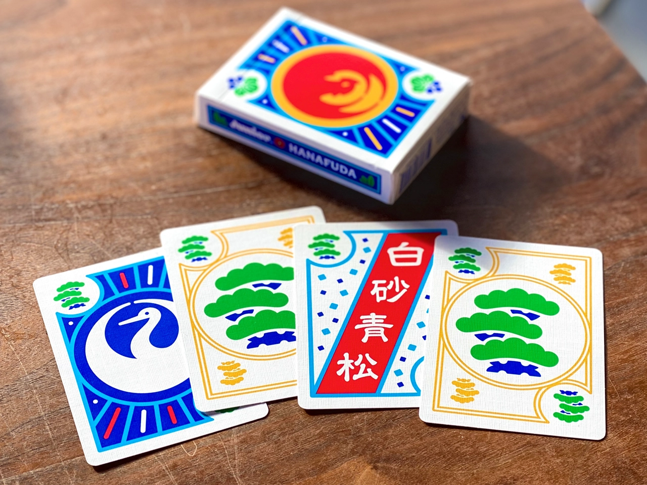 Pine cards from Junior Hanafuda alongside the Phoenix tuckbox.